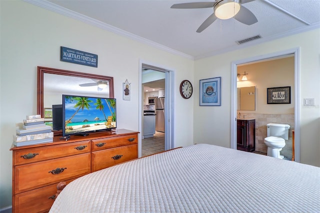 bedroom featuring ceiling fan, stainless steel refrigerator, ornamental molding, and connected bathroom