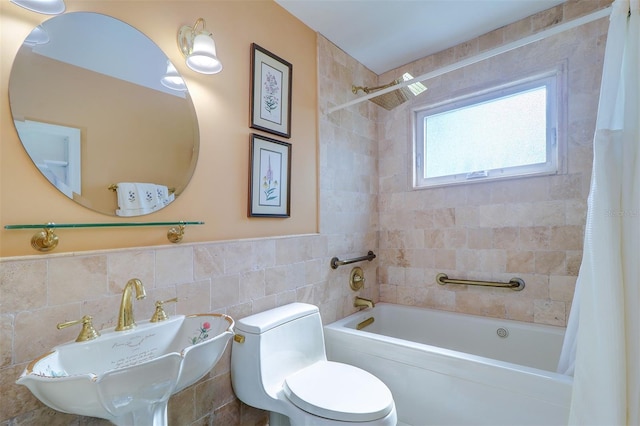 full bathroom with sink, shower / bath combo, tile walls, and toilet