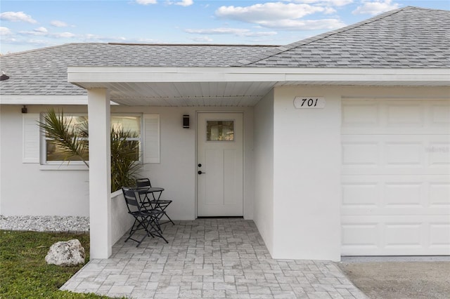 view of exterior entry featuring a garage