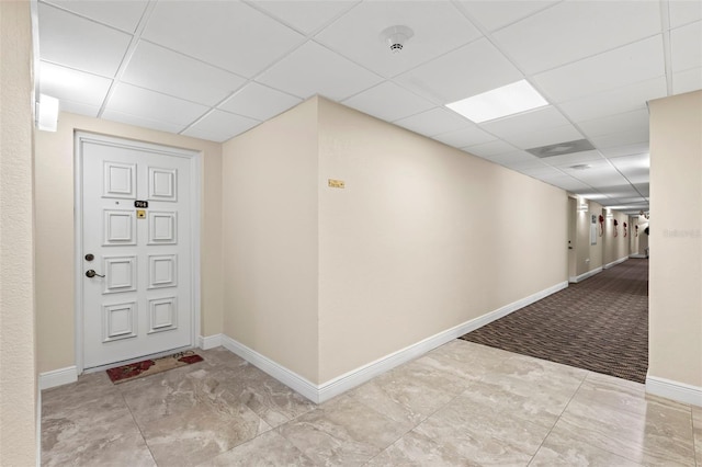 corridor featuring a paneled ceiling