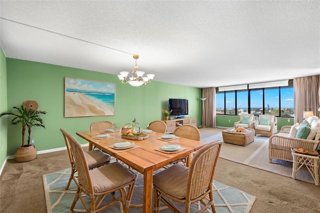 dining area featuring light colored carpet, a textured ceiling, and a chandelier