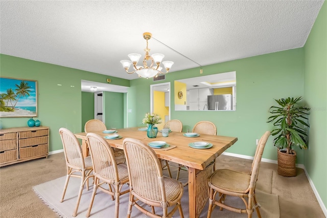 dining area featuring a textured ceiling and a notable chandelier