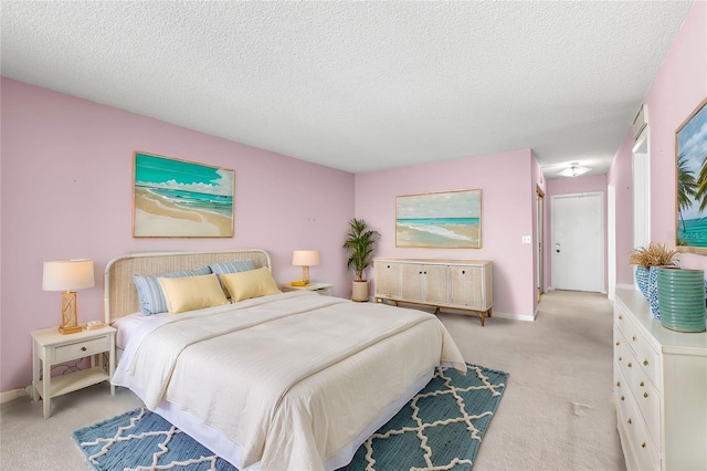 bedroom featuring light carpet and a textured ceiling