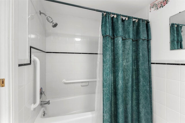 bathroom with shower / tub combo and tile walls