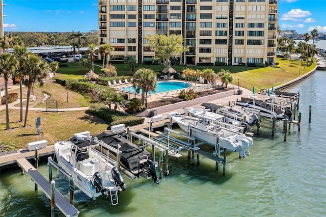 view of dock featuring a water view and a community pool