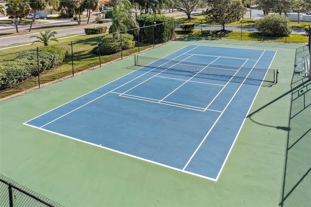 view of tennis court featuring basketball hoop