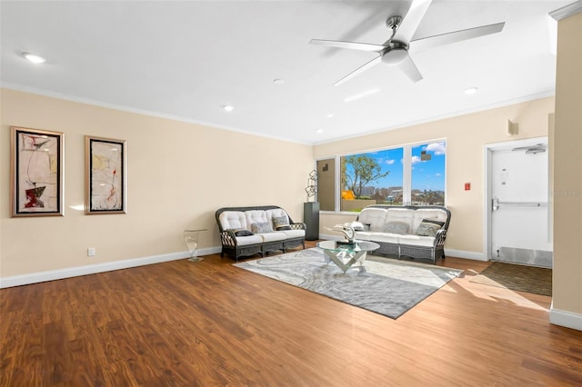 living room with crown molding, hardwood / wood-style floors, and ceiling fan