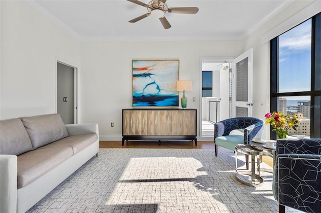 living room with wood-type flooring, ceiling fan, and ornamental molding