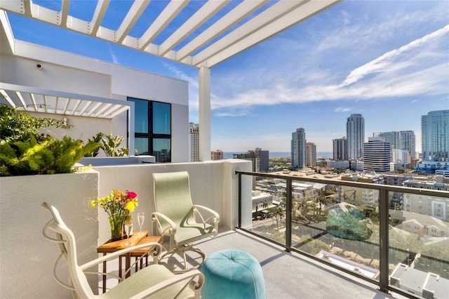 balcony with a view of city and a pergola