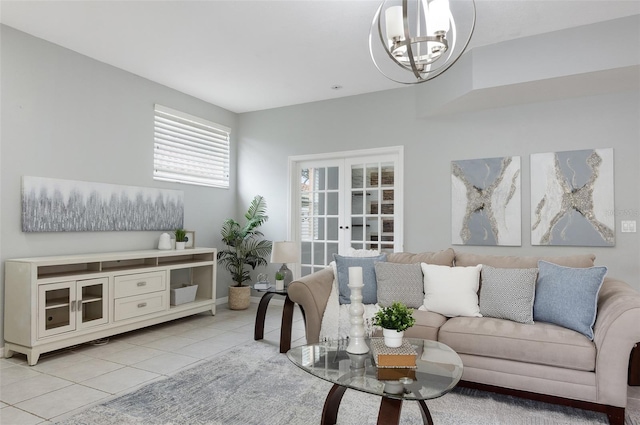 tiled living room with a chandelier and french doors