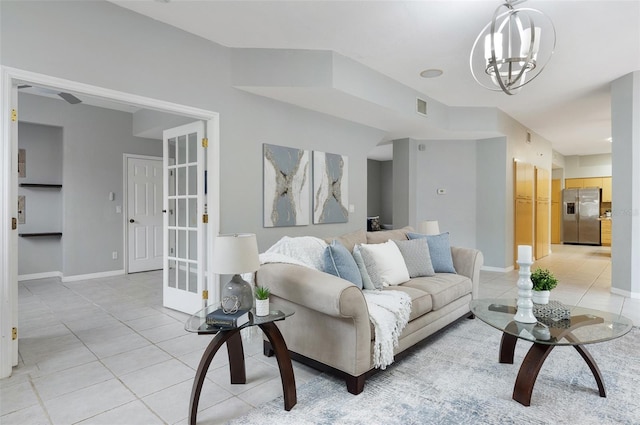 living room featuring light tile patterned floors and an inviting chandelier