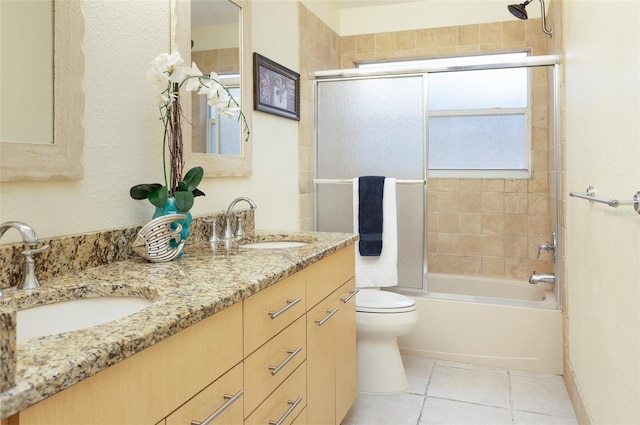 full bathroom featuring enclosed tub / shower combo, vanity, toilet, and tile patterned flooring