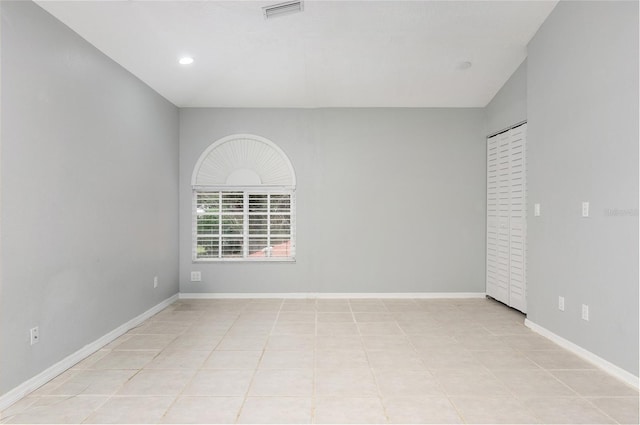 spare room with lofted ceiling