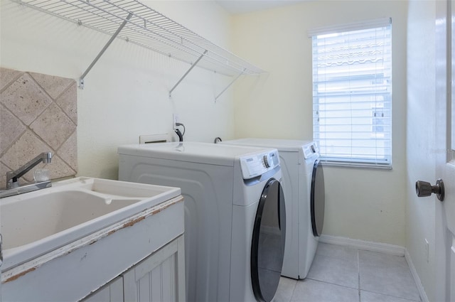 washroom featuring light tile patterned floors, sink, and independent washer and dryer