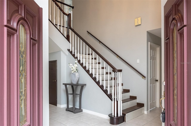 entrance foyer featuring a high ceiling and light tile patterned floors