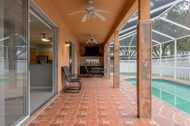 view of patio / terrace with a fenced in pool, glass enclosure, and ceiling fan