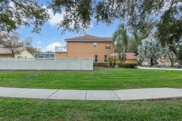 view of side of home with a lawn