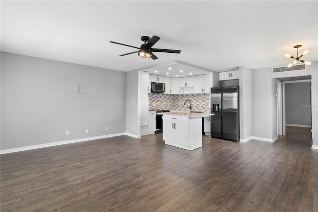 kitchen featuring a center island, ceiling fan with notable chandelier, sink, white cabinetry, and stainless steel appliances