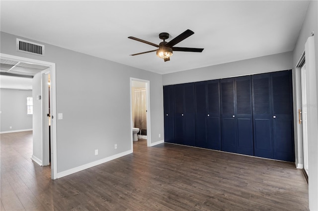 unfurnished bedroom with ensuite bath, ceiling fan, and dark hardwood / wood-style floors