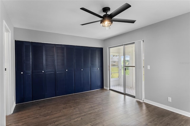 unfurnished bedroom featuring dark hardwood / wood-style floors and ceiling fan