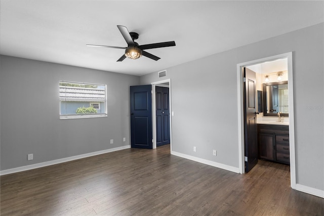 unfurnished bedroom with dark hardwood / wood-style floors, ensuite bath, ceiling fan, and sink