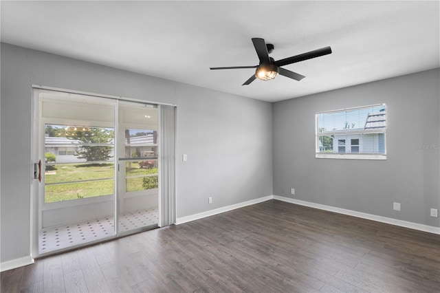 empty room with ceiling fan and dark wood-type flooring