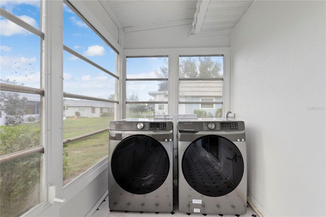 laundry room featuring washer and clothes dryer and a healthy amount of sunlight