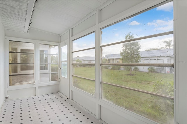 unfurnished sunroom with lofted ceiling