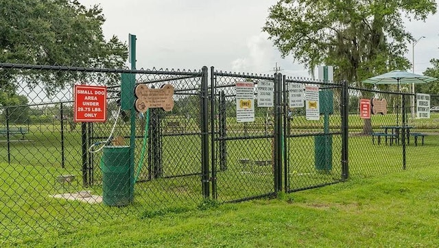 view of gate featuring a yard