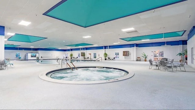 view of swimming pool featuring an indoor hot tub