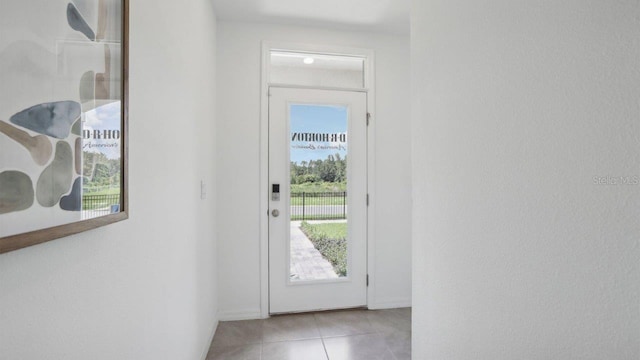 doorway to outside featuring light tile patterned floors and a wealth of natural light