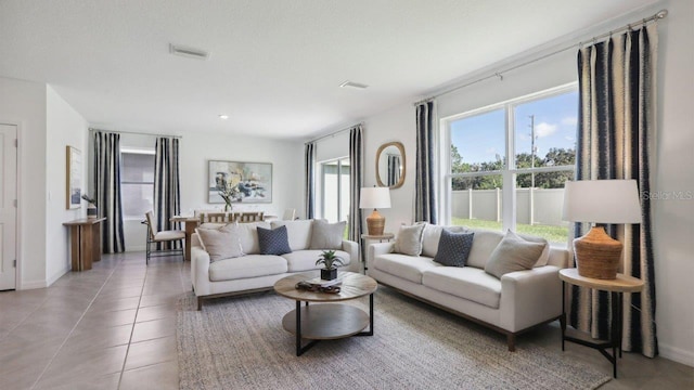 living room with light tile patterned floors and a textured ceiling