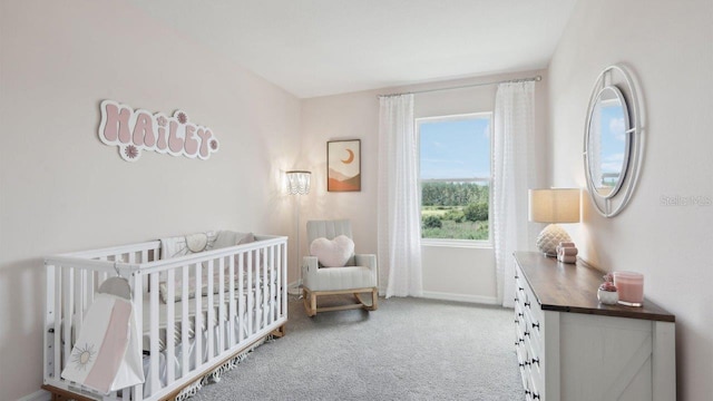 bedroom featuring light colored carpet and a crib