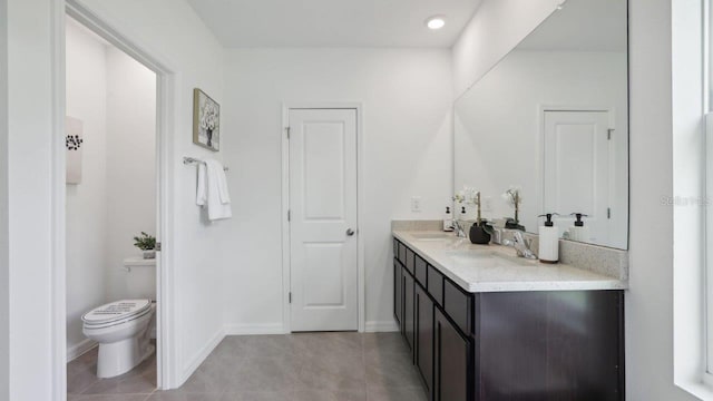 bathroom featuring tile patterned flooring, vanity, and toilet