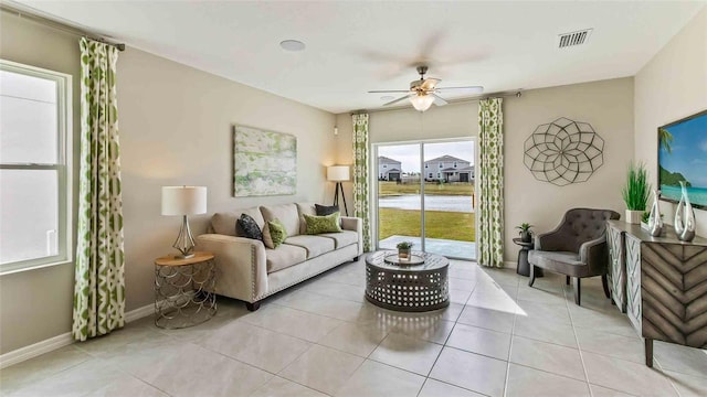 living room with ceiling fan and light tile patterned flooring