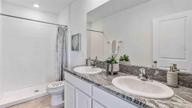 bathroom featuring tile patterned flooring, a shower with curtain, toilet, and vanity