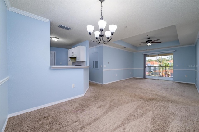 unfurnished living room featuring light carpet, ceiling fan with notable chandelier, a raised ceiling, crown molding, and a textured ceiling