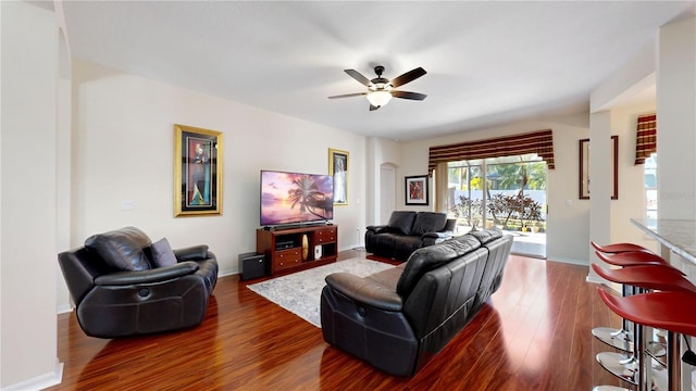 living room featuring dark hardwood / wood-style floors and ceiling fan