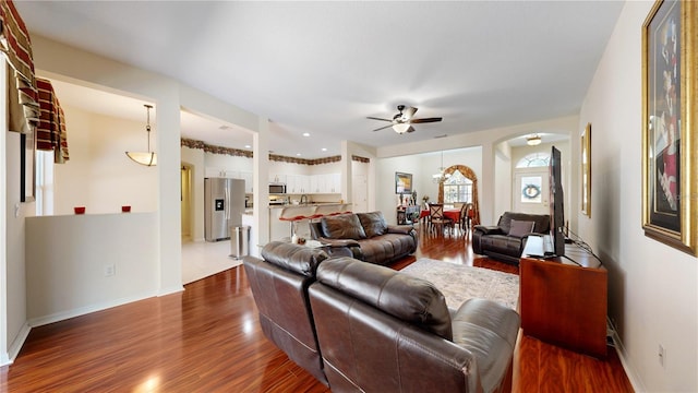 living room with hardwood / wood-style flooring and ceiling fan