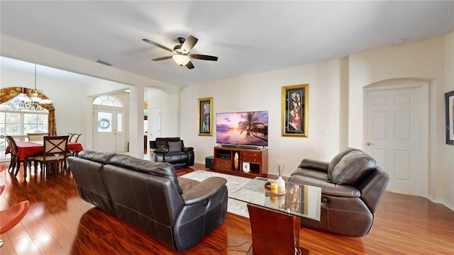 living room featuring wood-type flooring and ceiling fan