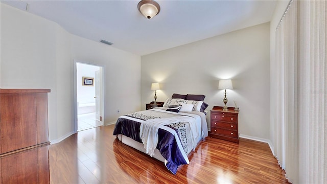 bedroom with wood-type flooring