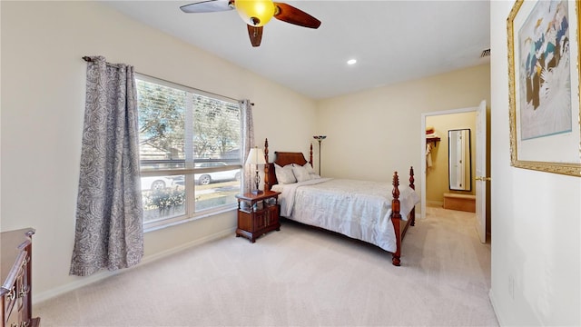 bedroom with ceiling fan, light carpet, and multiple windows