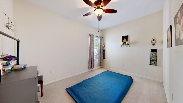 living area featuring light carpet and ceiling fan