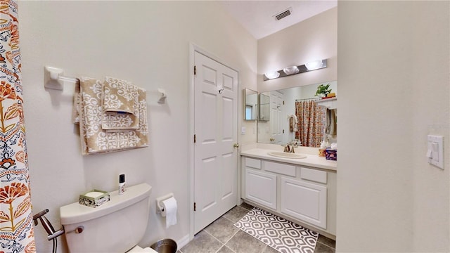 bathroom featuring tile patterned floors, vanity, and toilet