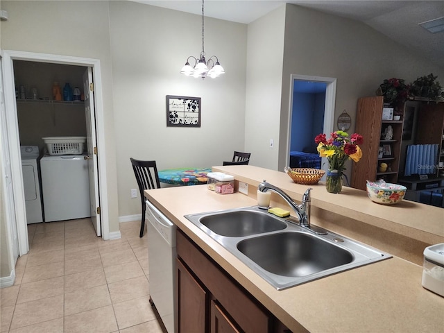 kitchen with sink, decorative light fixtures, an inviting chandelier, washing machine and clothes dryer, and dishwasher