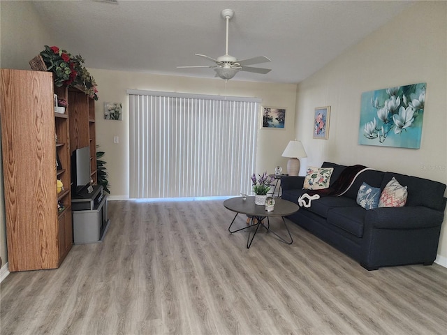 living room featuring ceiling fan and light hardwood / wood-style floors