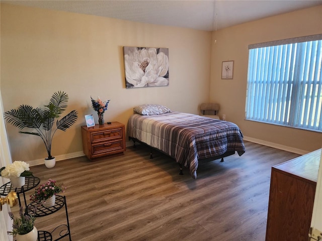 bedroom with dark hardwood / wood-style flooring