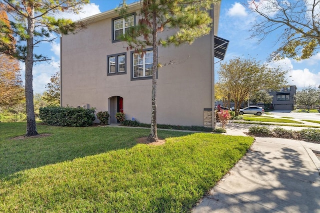 view of side of home with a lawn