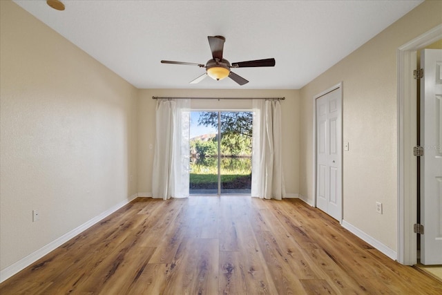 unfurnished room featuring ceiling fan and light wood-type flooring