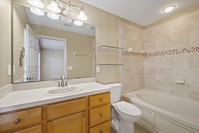 full bathroom featuring a textured ceiling, vanity, toilet, and tiled shower / bath